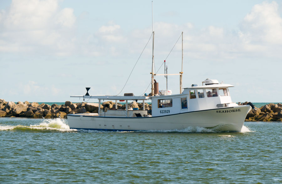 A shrimp fishing boat charter sails in the waters off nearby St George Island coast in Florida. Editorial credit: Leigh Trail, Shutterstock.com, licensed. 