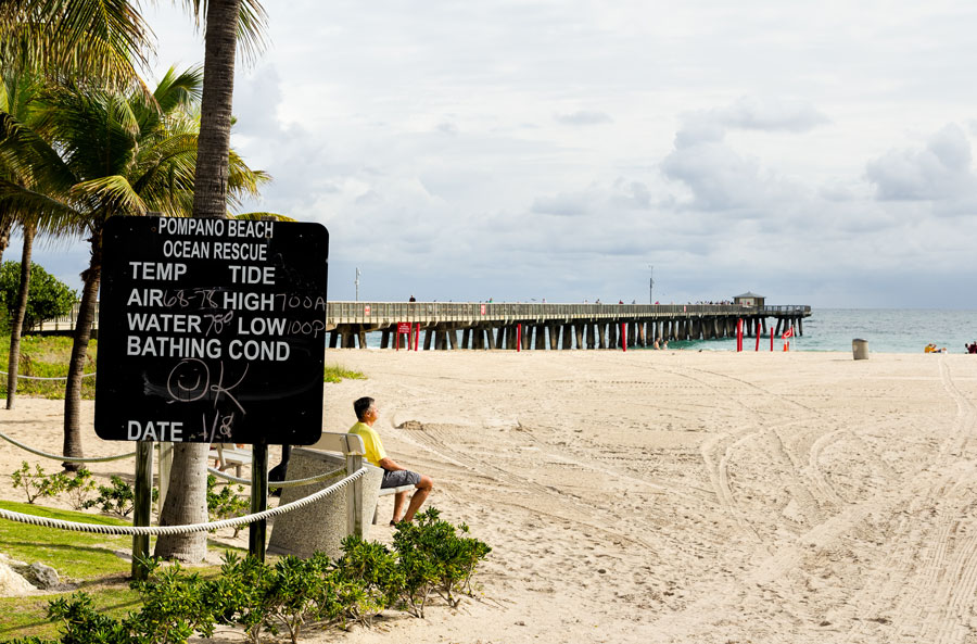 Fishing pier and weather information board photographed on January 8, 2016 in Pompano beach, Florida