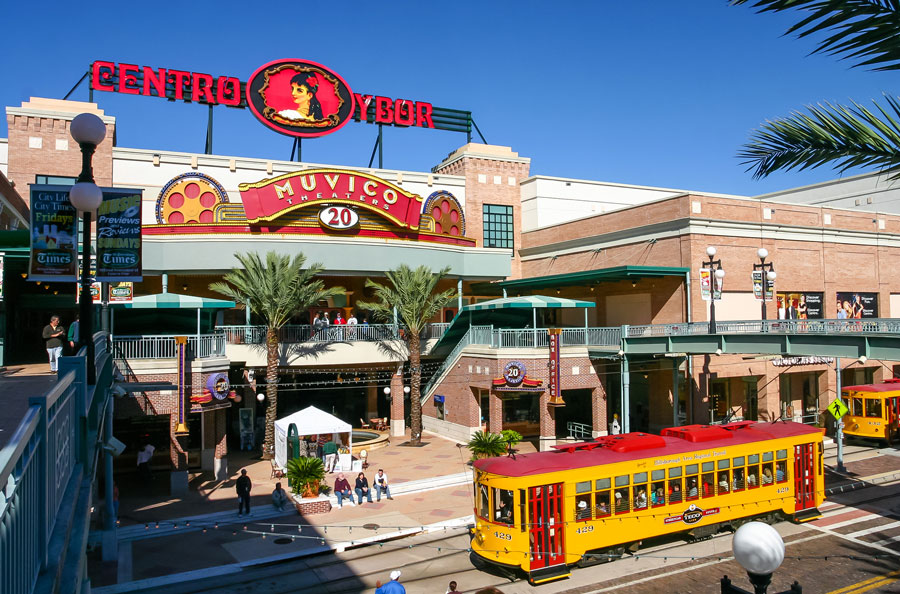 Centro Ybor entrance with yellow trams and visiting tourists, Tampa, FL. November 29, 2003. File photo: Pixachi, Shutterstock.com, licensed.