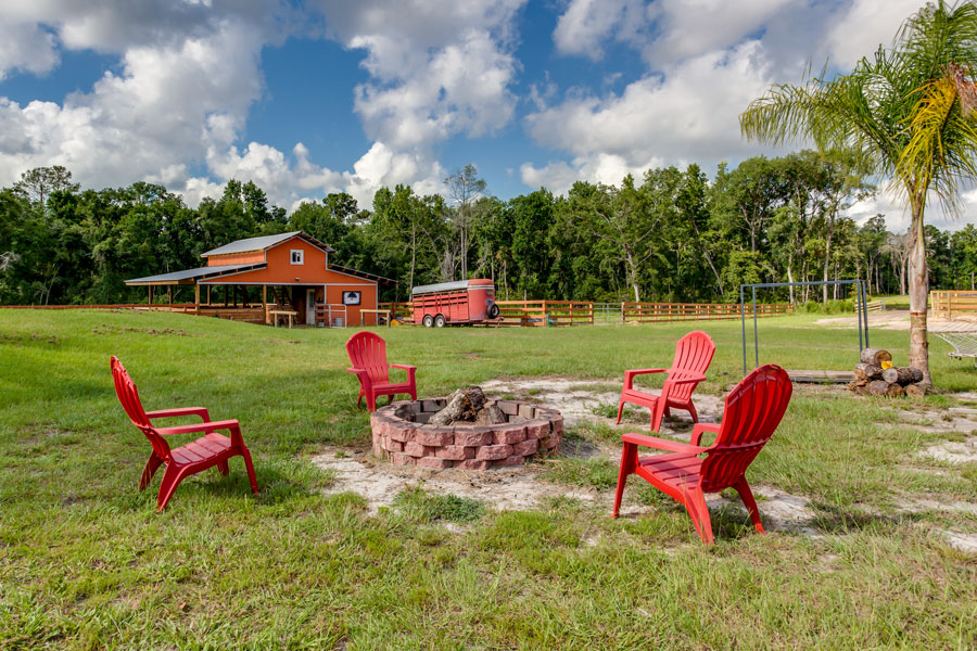 Fire pit in a backyard with a horse stable on October 17, 2019 Keystone Heights, Florida. 