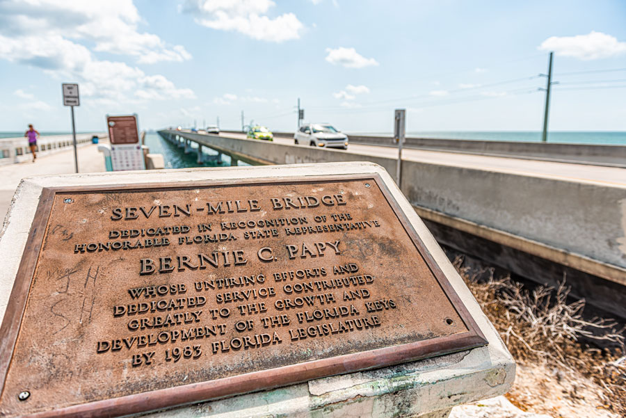 Old Seven Mile Knights Key-Pigeon Key-Moser Channel-Pacet Channel Bridge by overseas highway road near ocean with sign for Bernie Papy
