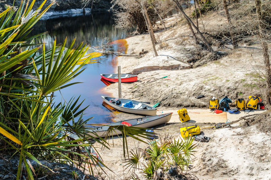 Canoes and gear packs on the beach, ready for a trip down the Swannee River in Florida. File photo: Nolichuckyjake, Shutter Stock, licensed.  